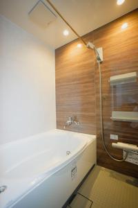 a bathroom with a white tub and a shower at 碧 AO Antik&Bay in Takamatsu +47 photos