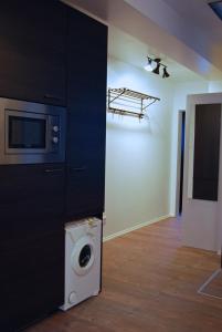 a room with a washing machine and a microwave at Jordan Suite Executive Furnished Apartment in Düsseldorf