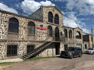 a car parked in front of a stone building at Mirage in Shinuhayr