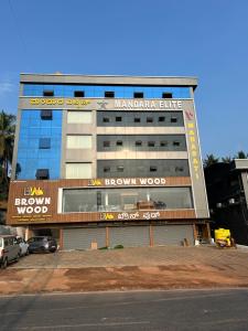 a building with a sign that reads brown wood at Mandara Elite in Kumta