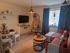 a living room with a couch and a table at PIK-KWATERY in Olsztyn