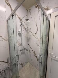 a shower stall with a glass door in a bathroom at Miva in Qusar