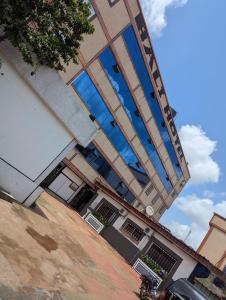a building with blue windows on the side of it at BALI HOTEl in Yaoundé