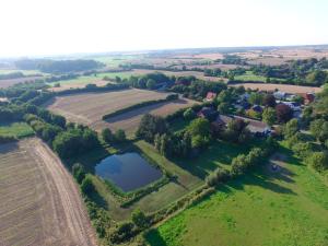 an aerial view of a farm with a pond at Ferienhaus Schlei in Rabenkirchen-Faulück