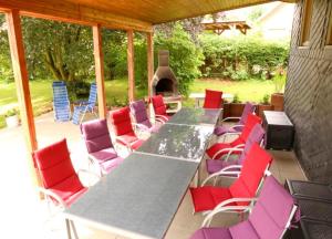 a table and chairs on a patio with a fireplace at Ferienhaus Schlei in Rabenkirchen-Faulück +10 photos