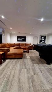 a living room with a couch and a pool table at Strode House in Knysna