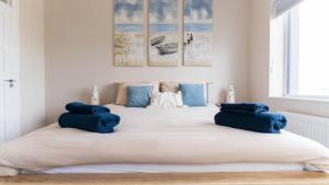 a bedroom with a large bed with blue pillows on it at Renard Haven - Cahersiveen in Cahersiveen