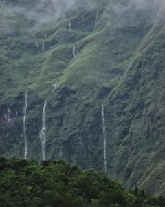 a waterfall on the side of a mountain at Sada 360 Nanu Homestay in Sembalun Lawang +3 photos