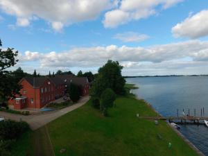a house on the shore of a body of water at Schleiblick App 2 in Rabenkirchen-Faulück +9 photos