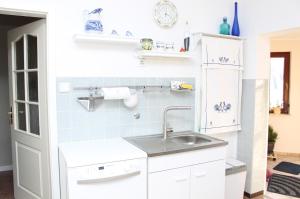 a small kitchen with a sink and a refrigerator at Haus Hahn in Suhlendorf +15 photos