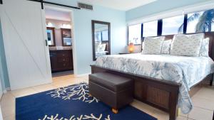 a bedroom with a bed and a mirror at 305 Kawama Tower in Key Largo +33 photos