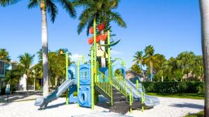 a playground with a slide in a park with palm trees at 305 Kawama Tower in Key Largo