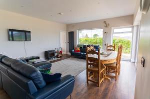 a living room with a couch and a table at Renard Haven - Cahersiveen in Cahersiveen
