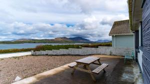 a wooden picnic table sitting on the side of a house at Renard Haven - Cahersiveen in Cahersiveen