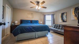 a bedroom with a bed and a ceiling fan at Treasure on Comal! in New Braunfels +25 photos
