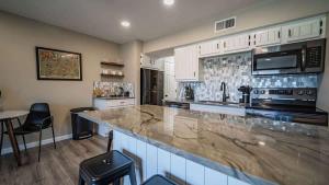 a large kitchen with a large marble counter top at Treasure on Comal! in New Braunfels
