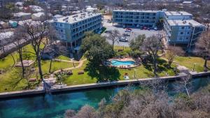 an aerial view of a building and a river at Treasure on Comal! in New Braunfels
