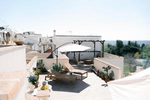 eine Terrasse mit zwei Stühlen und einem Tisch auf einem Dach in der Unterkunft La Carrera in Bernalda