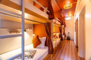 a room with bunk beds with a chess board on the bed at Madpackers Varanasi in Varanasi +33 photos