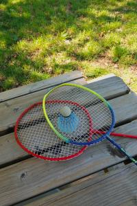 two tennis rackets sitting on a wooden table at Prullenbos Tiny House Nutz Nest in Wetteren