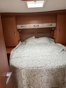 a bed in the back of an rv at Camping car Paris in Savigny-le-Temple +6 photos