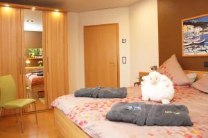 a bedroom with a bed with a teddy bear on it at Ferienwohnung Heuer in Ebstorf +16 photos