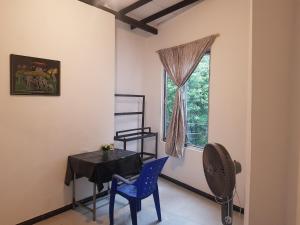 a dining room with a table and chairs and a window at Shalom View Homestay in Kandy