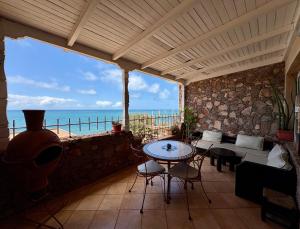 a patio with a table and chairs and the ocean at Appartement terrasse de la mer in Mirleft