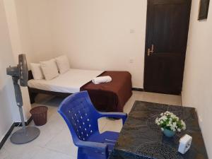 a small room with a bed and a table and a chair at Shalom View Homestay in Kandy