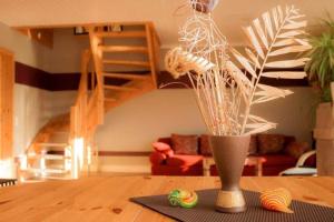 a living room with a vase on a table at Haus Sonnenschein in Dänschendorf