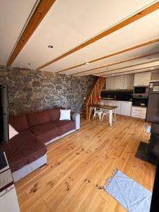 a living room with a couch and a table at Casa do terno com piscina in Arco da Calheta