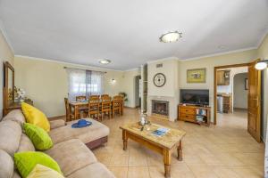 a living room with a couch and a table at Villa Teotel by Villa Plus in Almancil