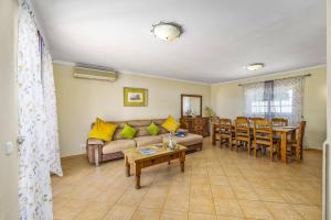 a living room with a couch and a table at Villa Teotel by Villa Plus in Almancil