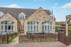 a house with a fence in front of it at 3 Bed in Chathill oc-61892 in Beadnell