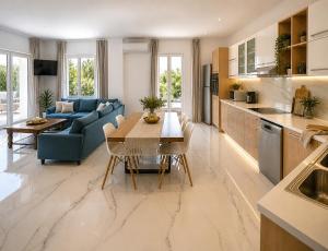 a kitchen and living room with a table and a couch at Hayeks Villa private pool near the beach in Daratso
