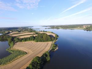 an aerial view of a farm on a river at Schleiblick App 18 in Rabenkirchen-Faulück +5 photos