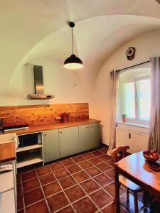 a kitchen with a table and a wooden counter top at Brick House in Fürstenfeld