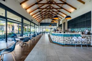 a restaurant with a bar with chairs and tables at Ballito Hills 369 in Ballito