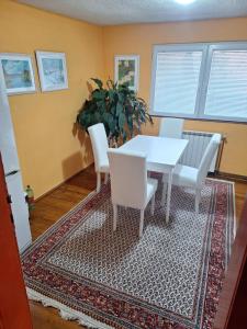 a dining room with a white table and white chairs at Modern&Cozy Bosnian house with GARDEN+FREE parking in Sarajevo +53 photos