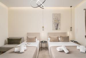 two beds and a chair in a room at Villa Dionysios in Keri +132 photos