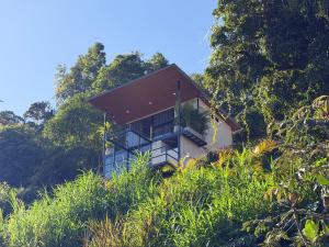 a house sitting on top of a hill at Payara Experience in La Vega