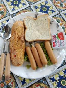 a plate of food with hot dogs and toast at Mumzai House 2 in Ko Muk