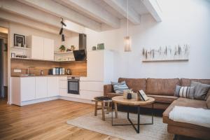 a living room with a couch and a table at Van Senden 5 Anni in Krummhörn