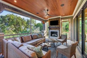 a screened in porch with a couch and a fireplace at SS59: 59 Surfsong in Kiawah Island
