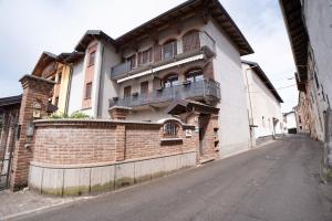 a building with balconies on the side of a street at Centenario Affittacamere in Fara Novarese
