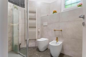 a bathroom with a toilet and a shower at Sunset on the Lake Belgirate in Belgirate +25 photos