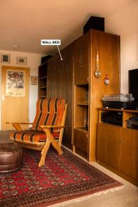 a living room with a chair and a wall ect at Peaceful Oasis Black Forest in Schonach