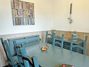 a table and chairs with a bowl of fruit on it at Irisdene in Tintagel