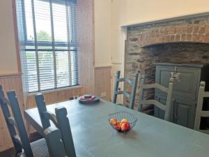 a dining room table with a bowl of fruit on it at Irisdene in Tintagel +15 photos