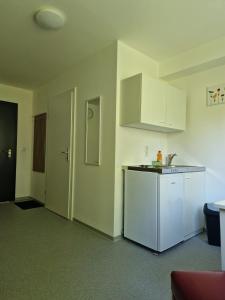 a kitchen with white cabinets and a counter top at Gruppenunterkunft für Firmen & Arbeiter in Laa an der Thaya in Laa an der Thaya